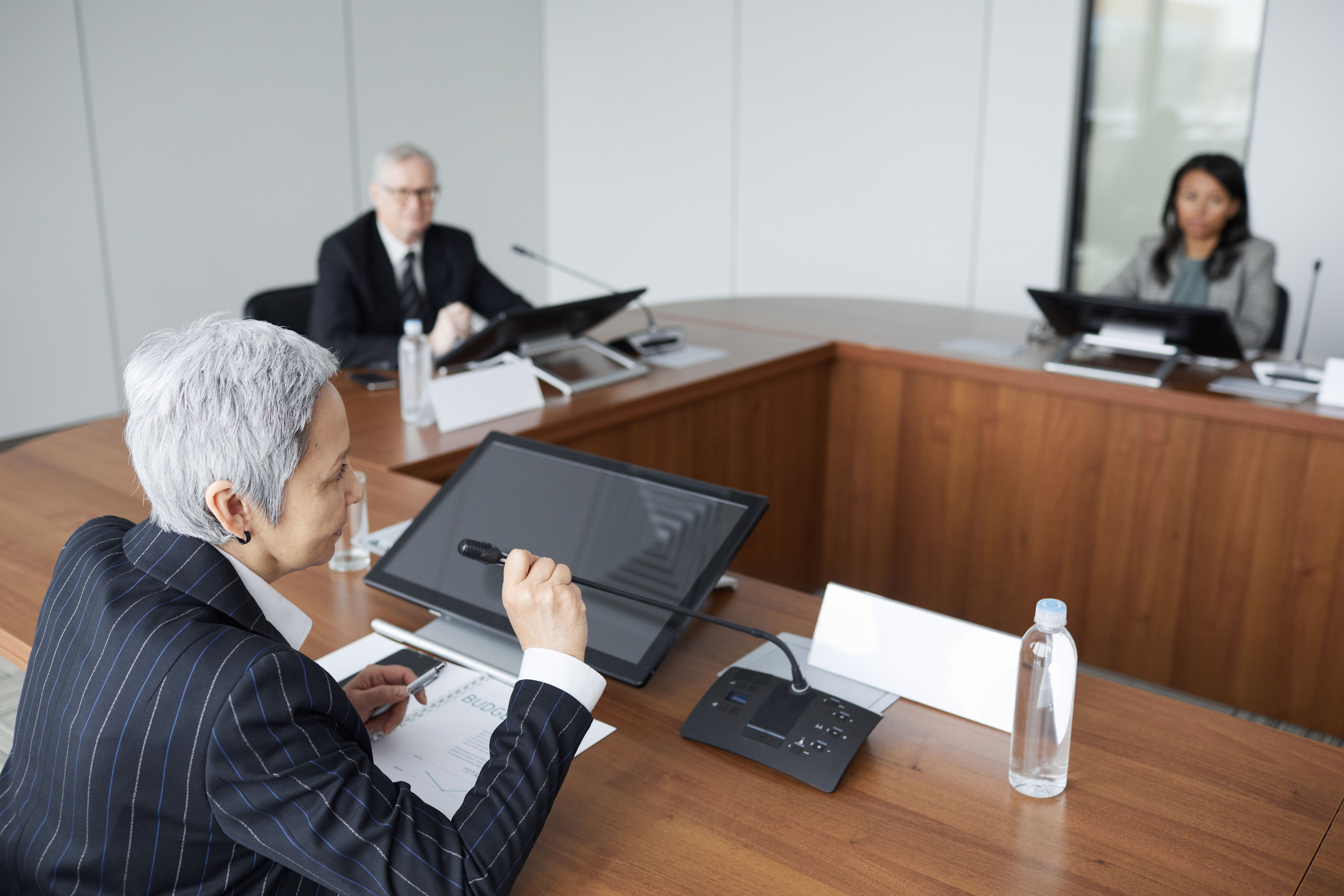 Senior executives discussing strategies in a modern boardroom setting