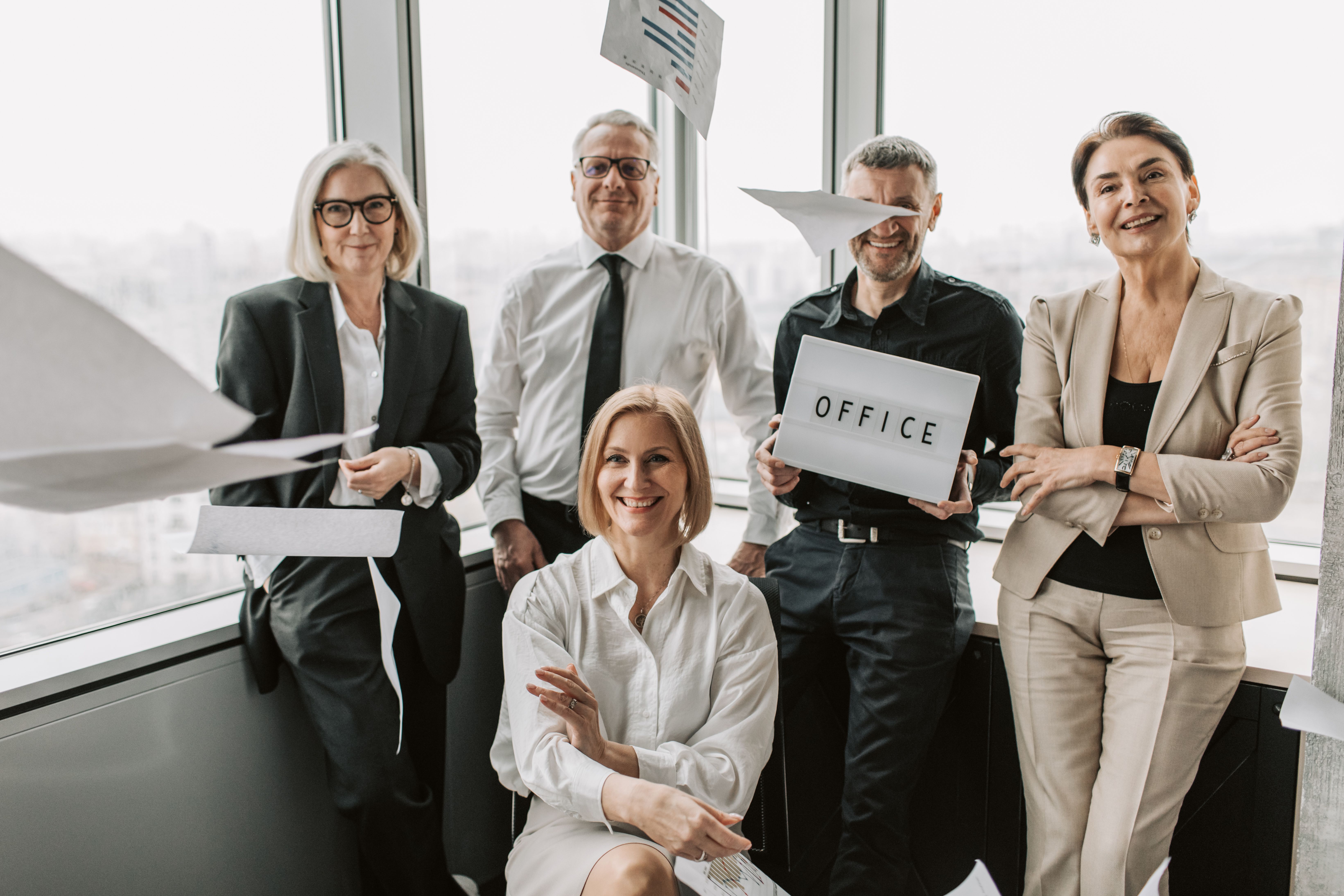 Group of business professionals celebrating achievements inside a modern office space