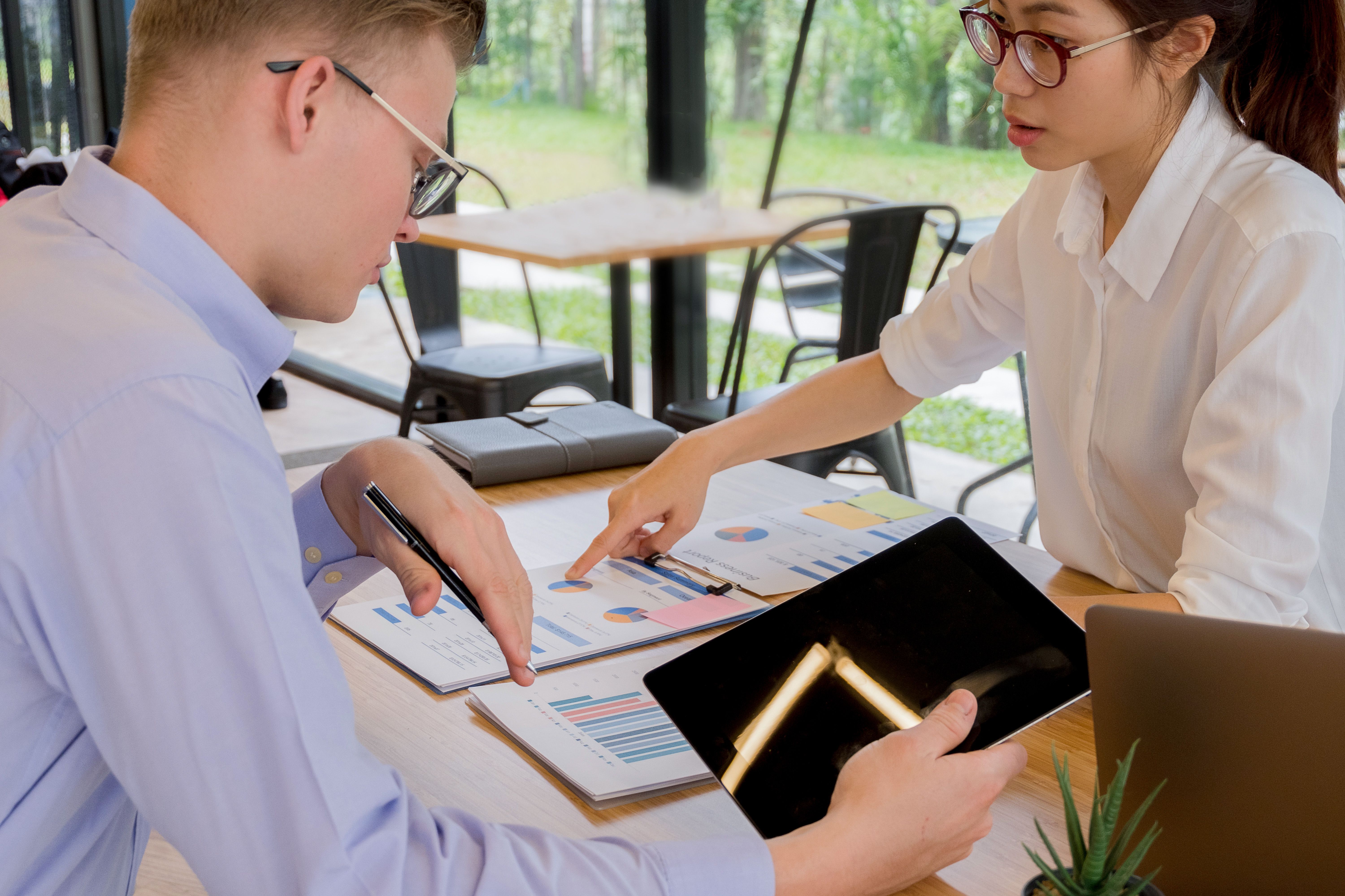 Professionals collaborating over financial documents, illustrating litigation finance investment decisions.
