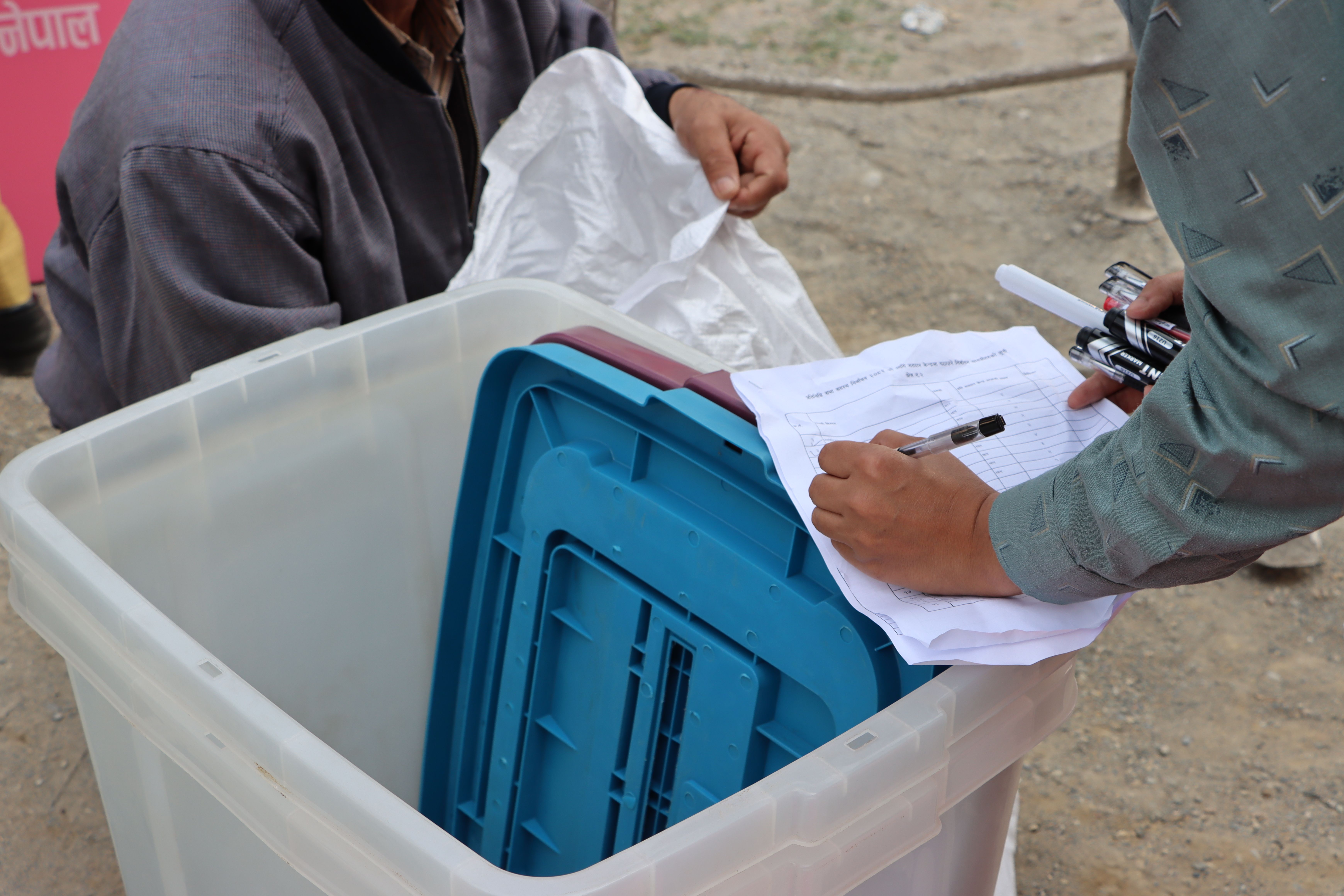 Election authorities managing a ballot box during a regional election